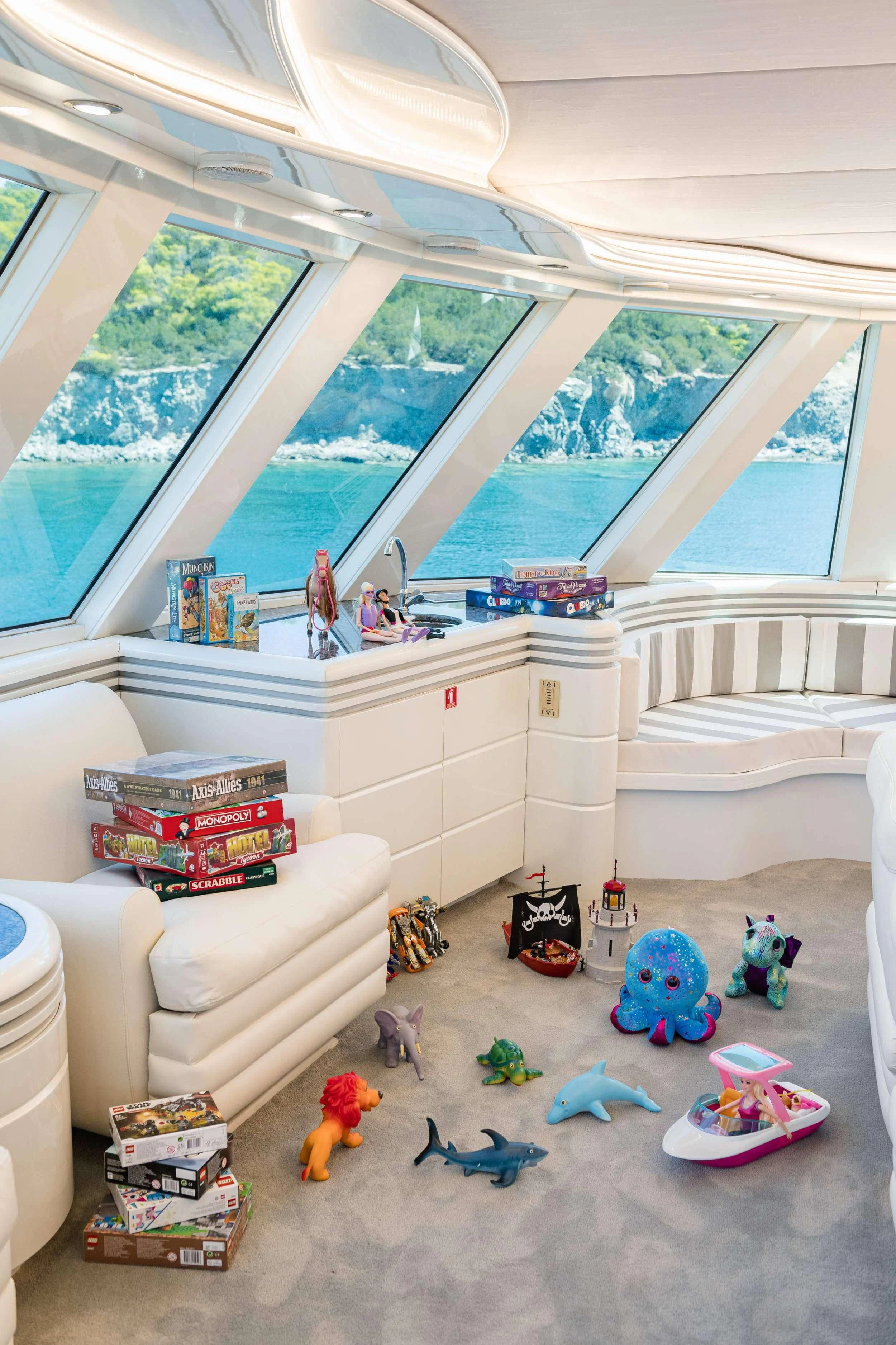 a room with a couch and toys aboard WIND OF FORTUNE Yacht for Charter