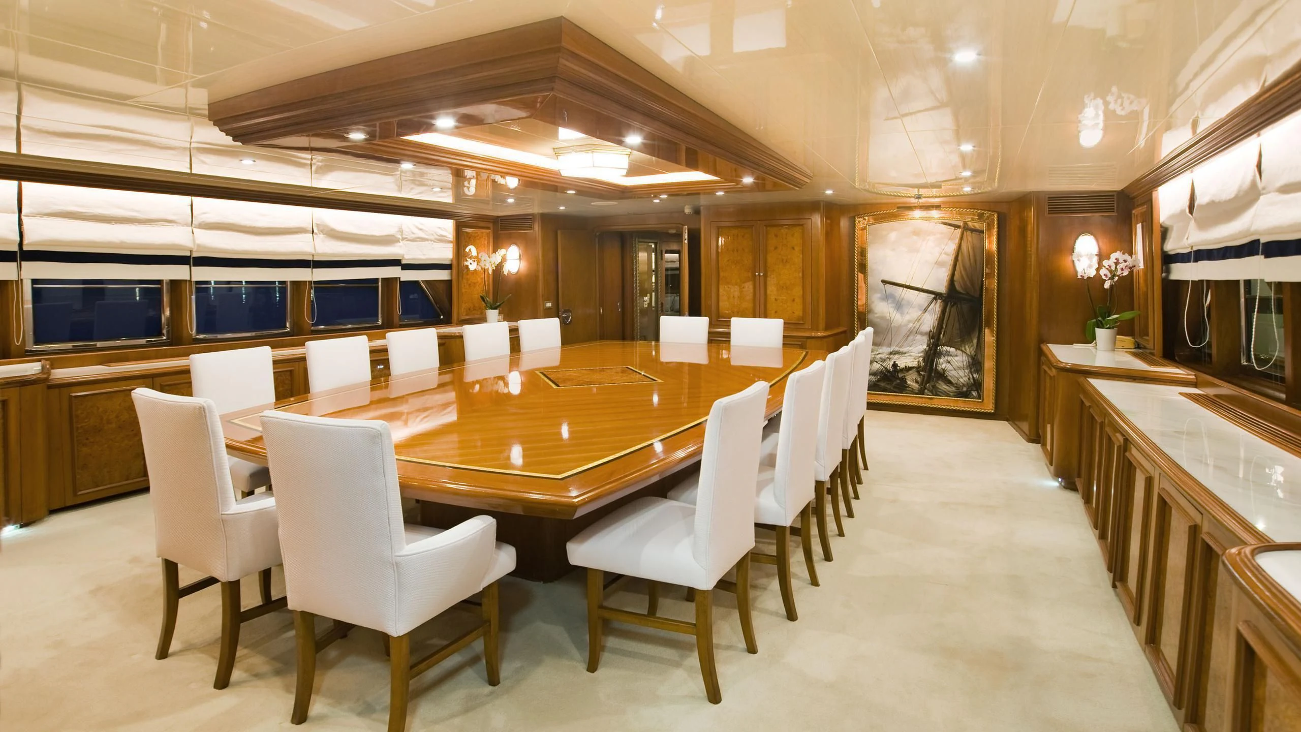 a large room with tables and chairs aboard WIND OF FORTUNE Yacht for Charter