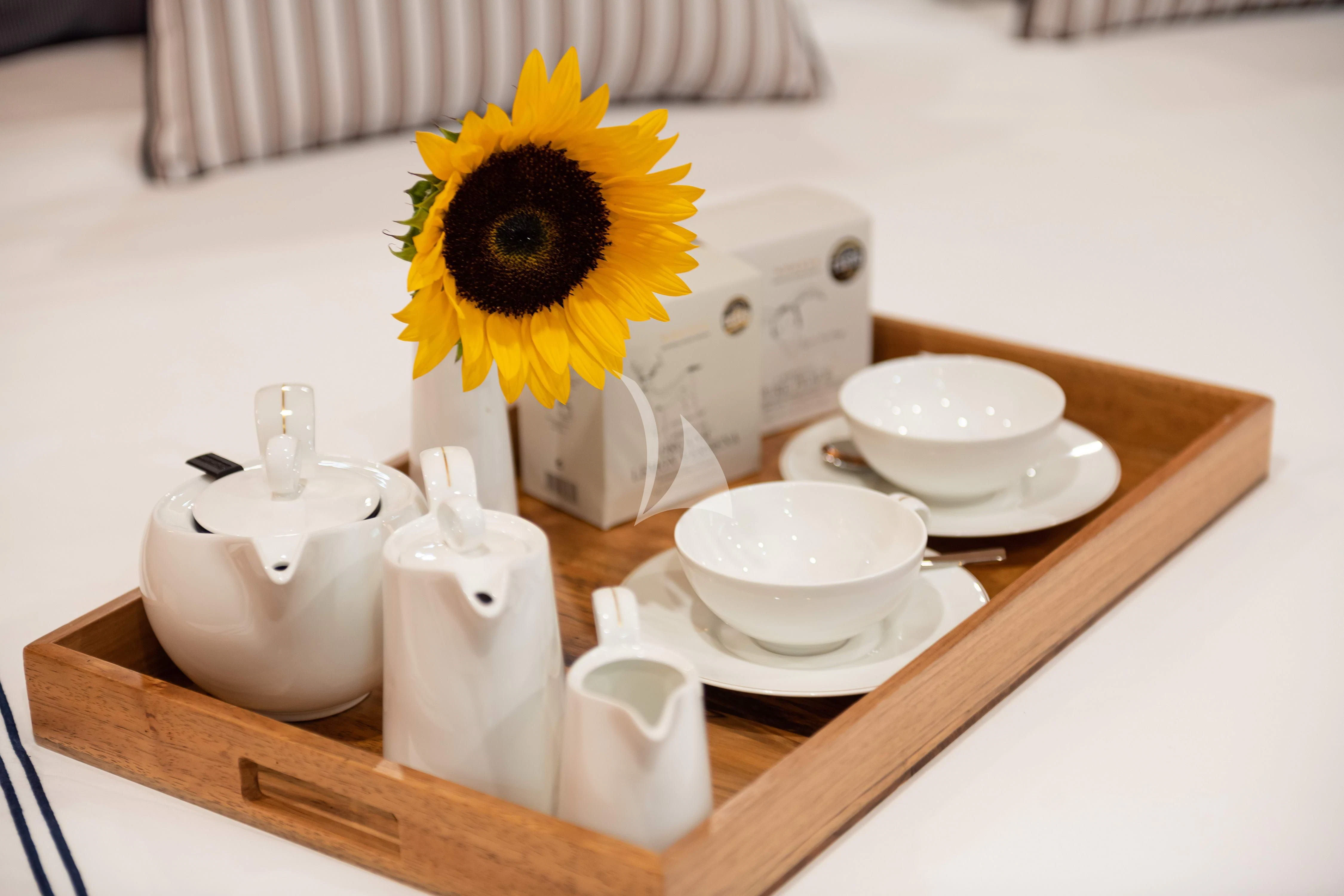a table with a vase and cups on it aboard WIND OF FORTUNE Yacht for Charter