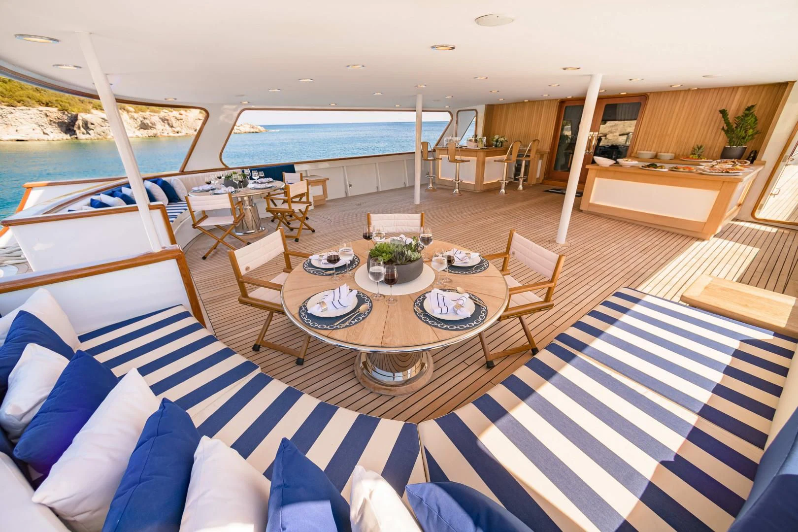 a room with a table and chairs aboard WIND OF FORTUNE Yacht for Charter