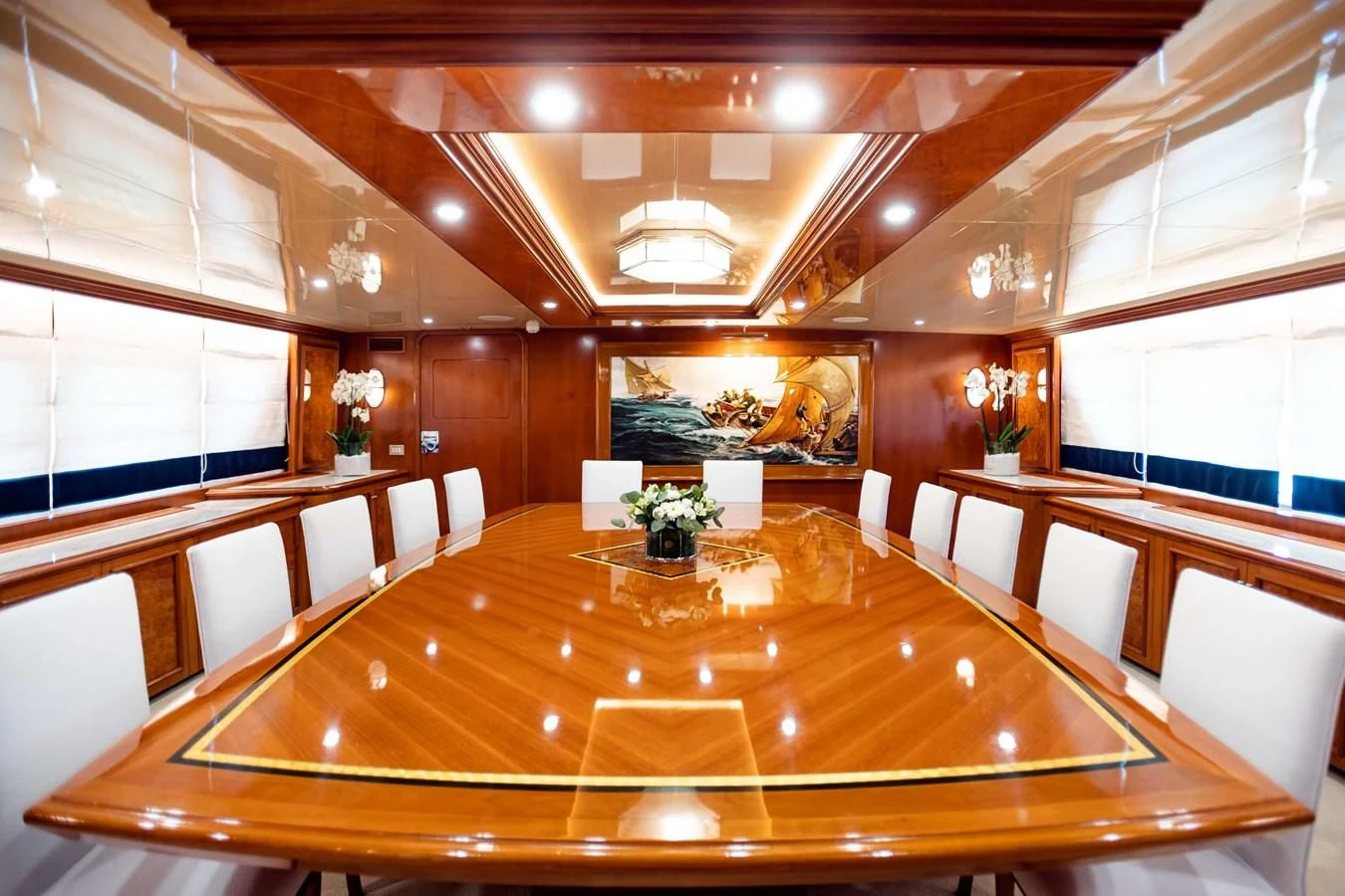 a room with tables and chairs aboard WIND OF FORTUNE Yacht for Charter