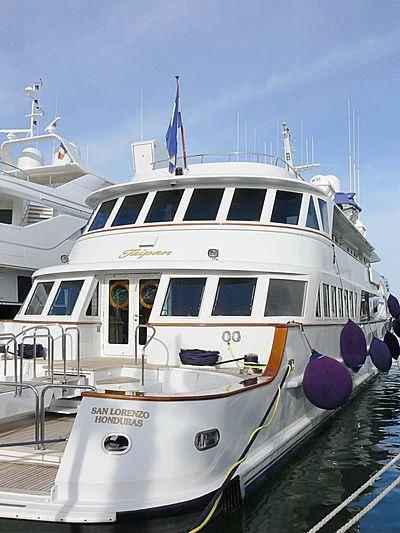 a white boat with blue and purple decorations aboard WIND OF FORTUNE Yacht for Charter