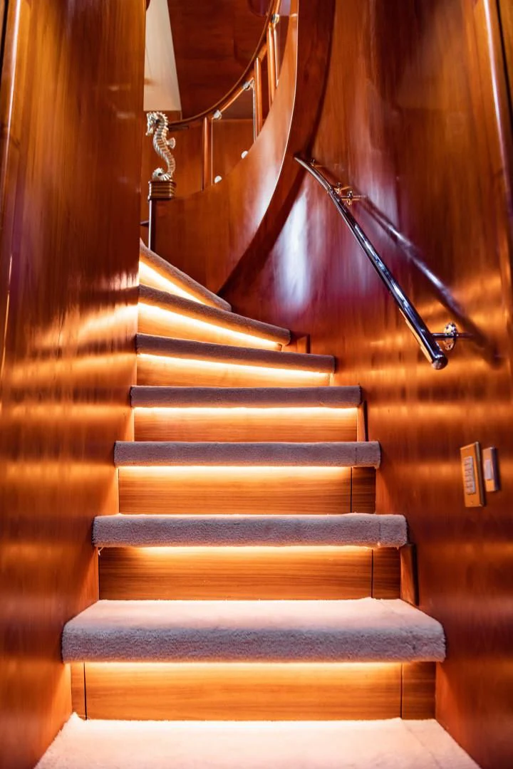 a staircase with a light aboard WIND OF FORTUNE Yacht for Charter
