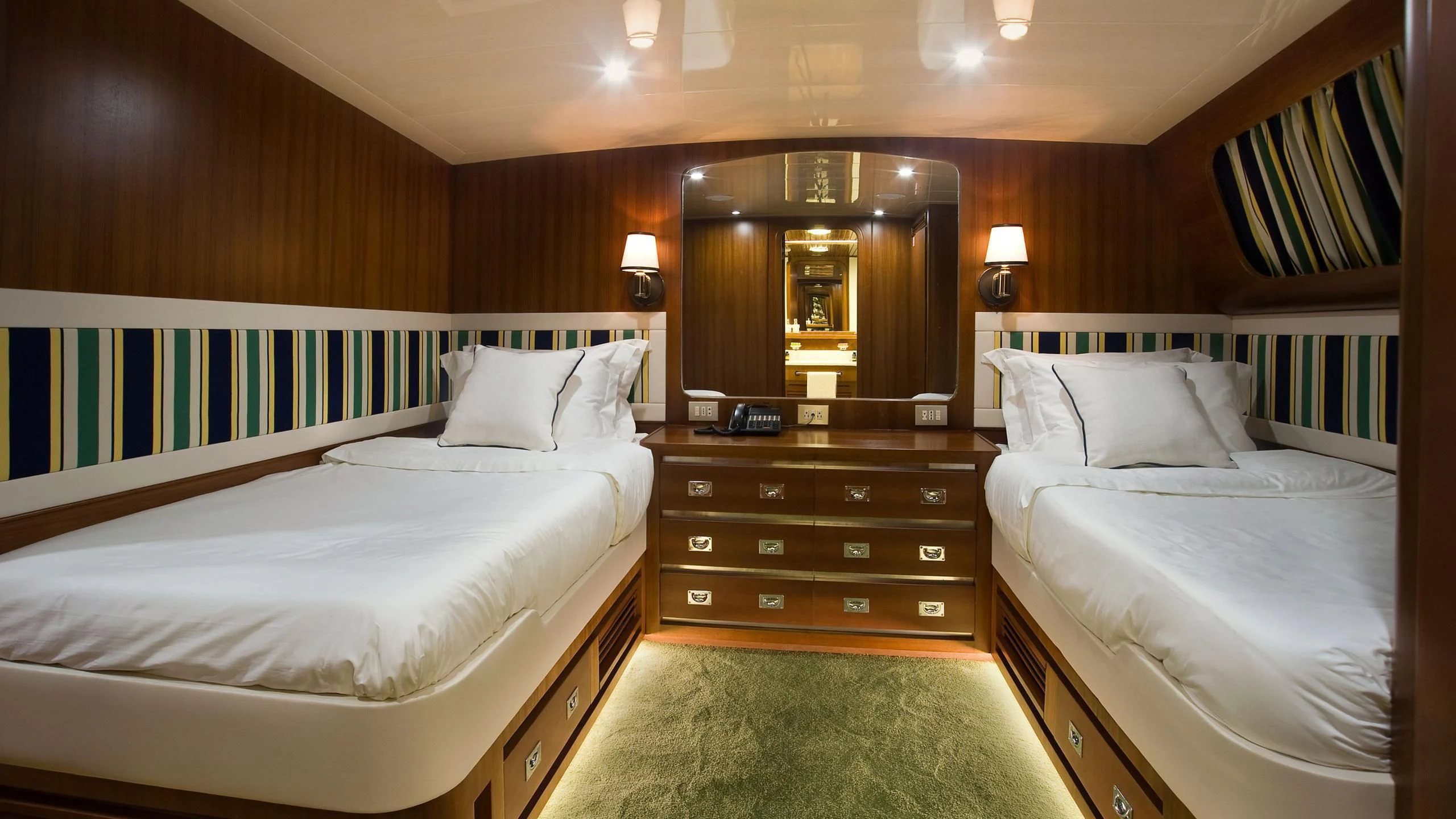 a room with a bed and a mirror aboard WIND OF FORTUNE Yacht for Charter