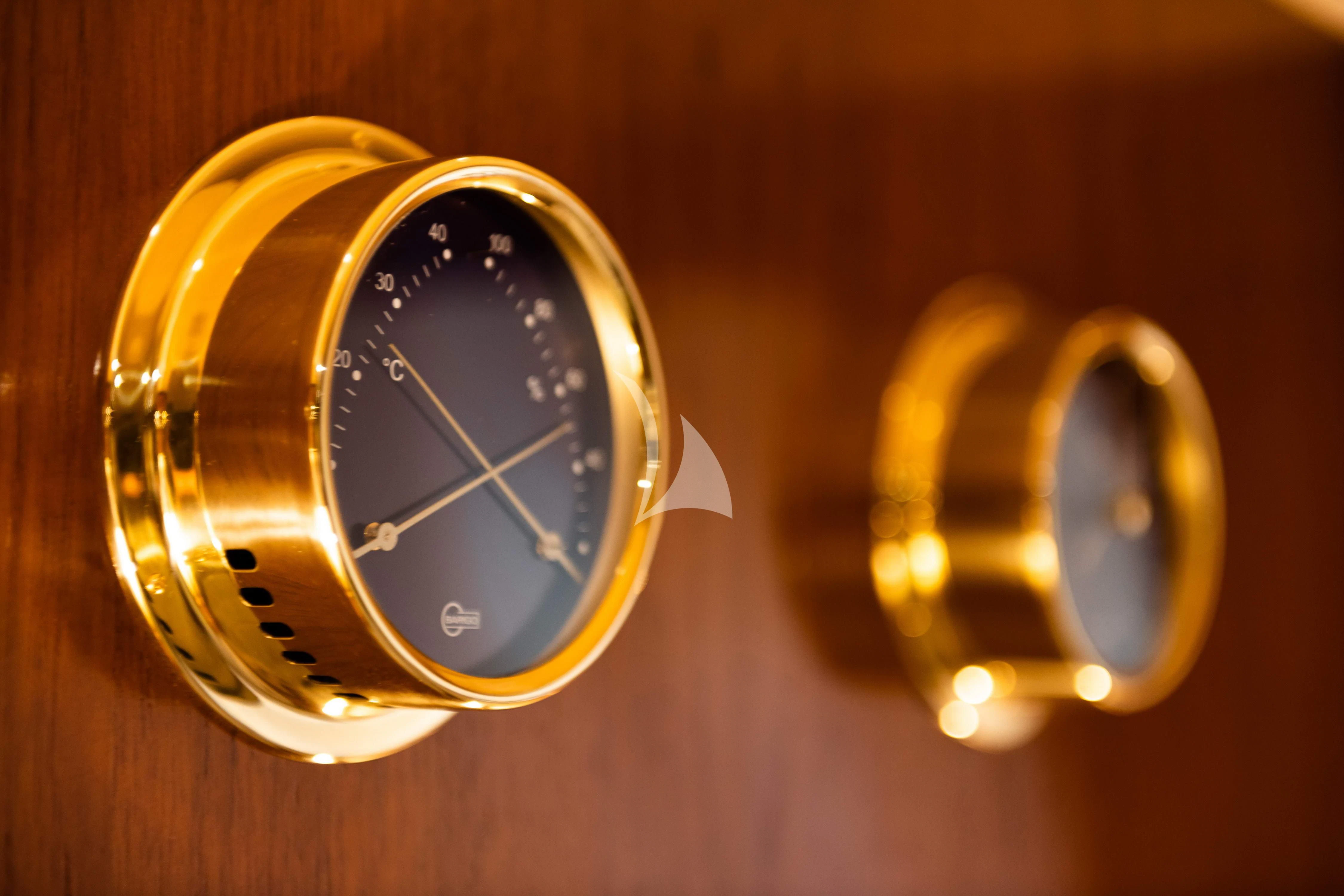 a gold watch with a silver face aboard WIND OF FORTUNE Yacht for Charter