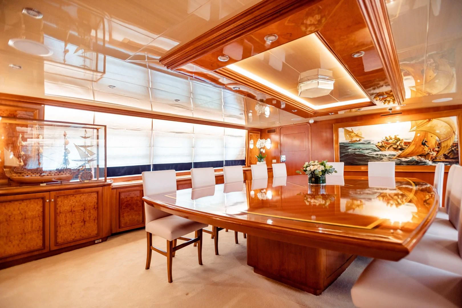 a large room with a table and chairs aboard WIND OF FORTUNE Yacht for Charter
