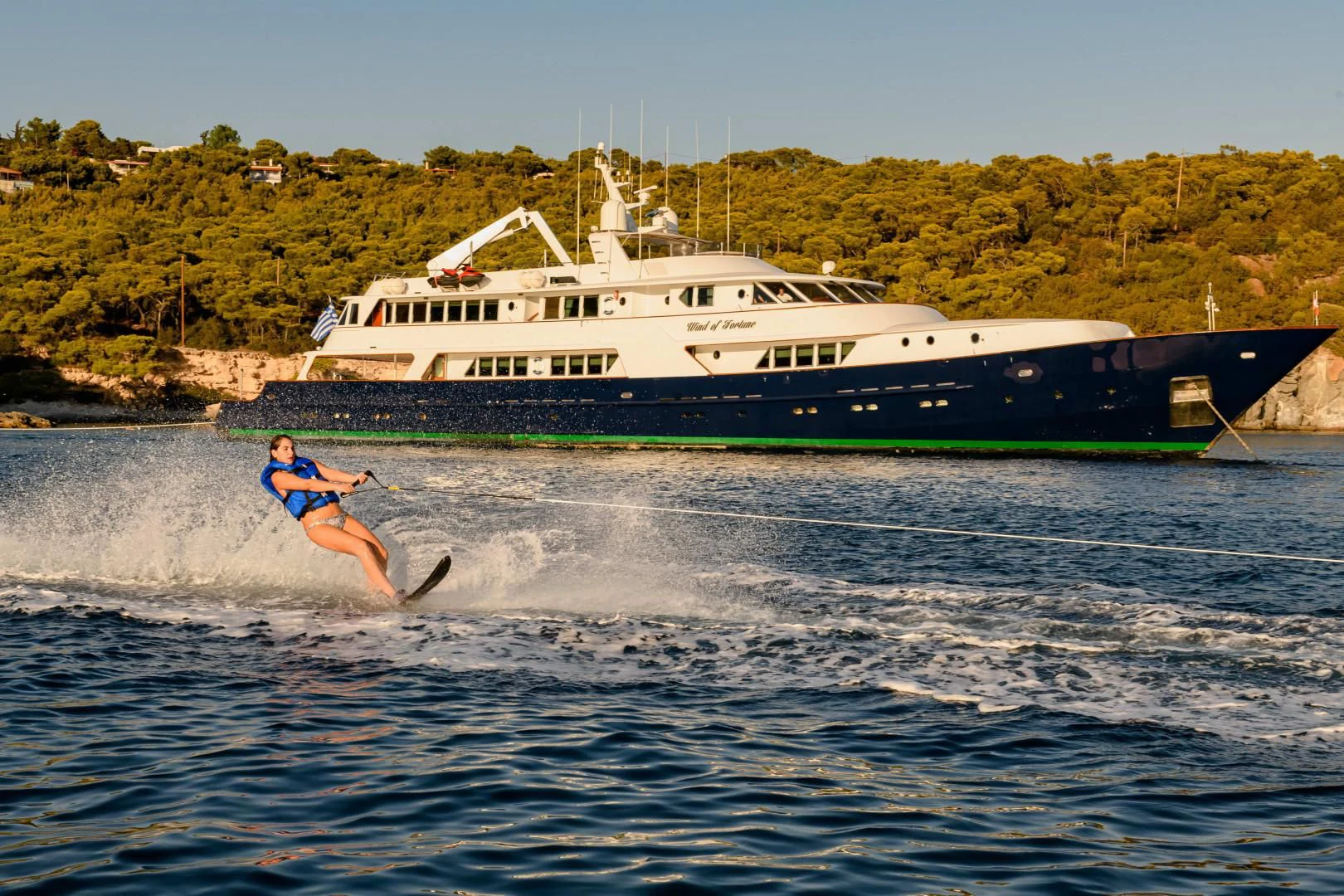a person water skiing aboard WIND OF FORTUNE Yacht for Charter