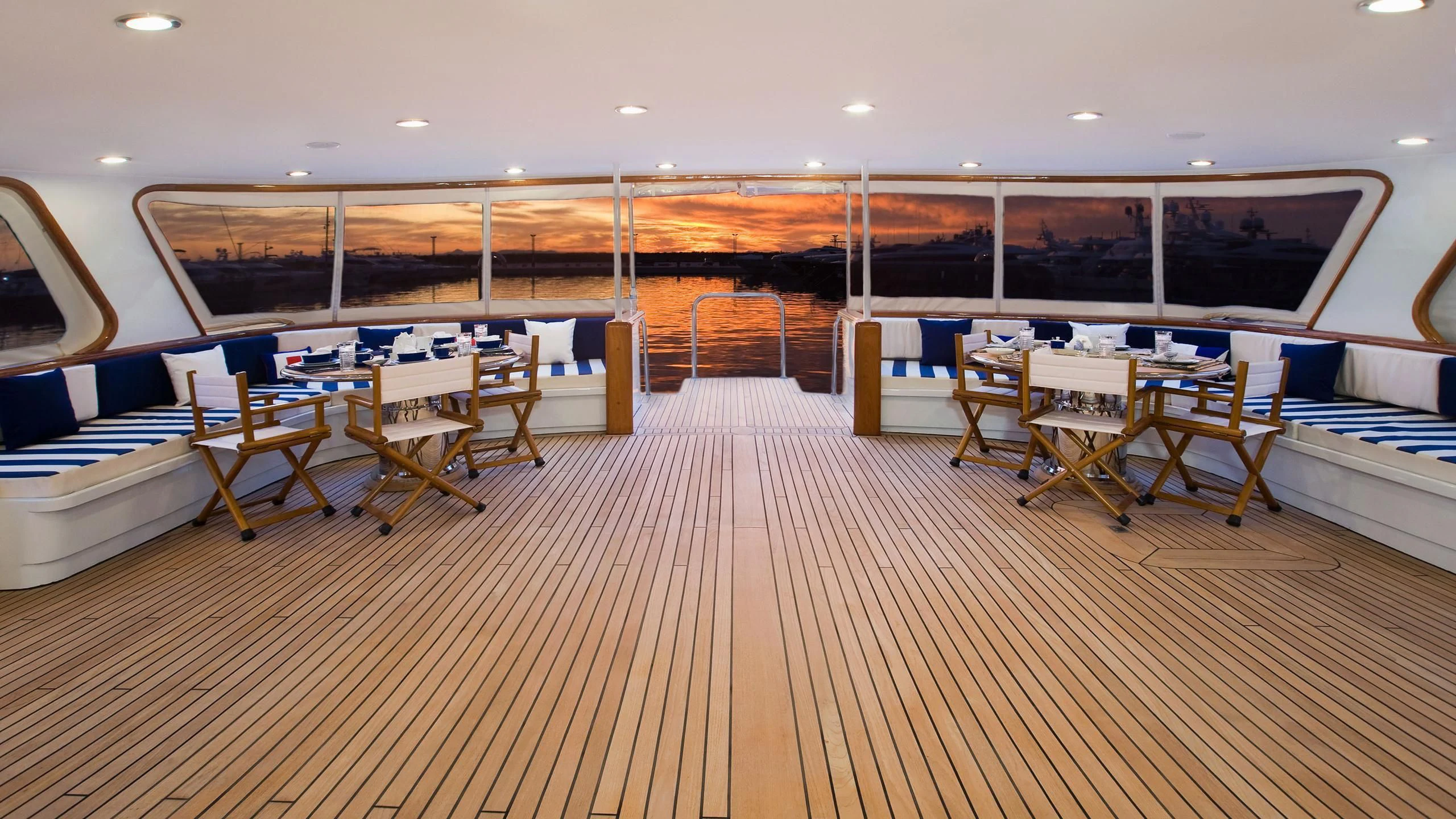 a room with tables and chairs aboard WIND OF FORTUNE Yacht for Charter