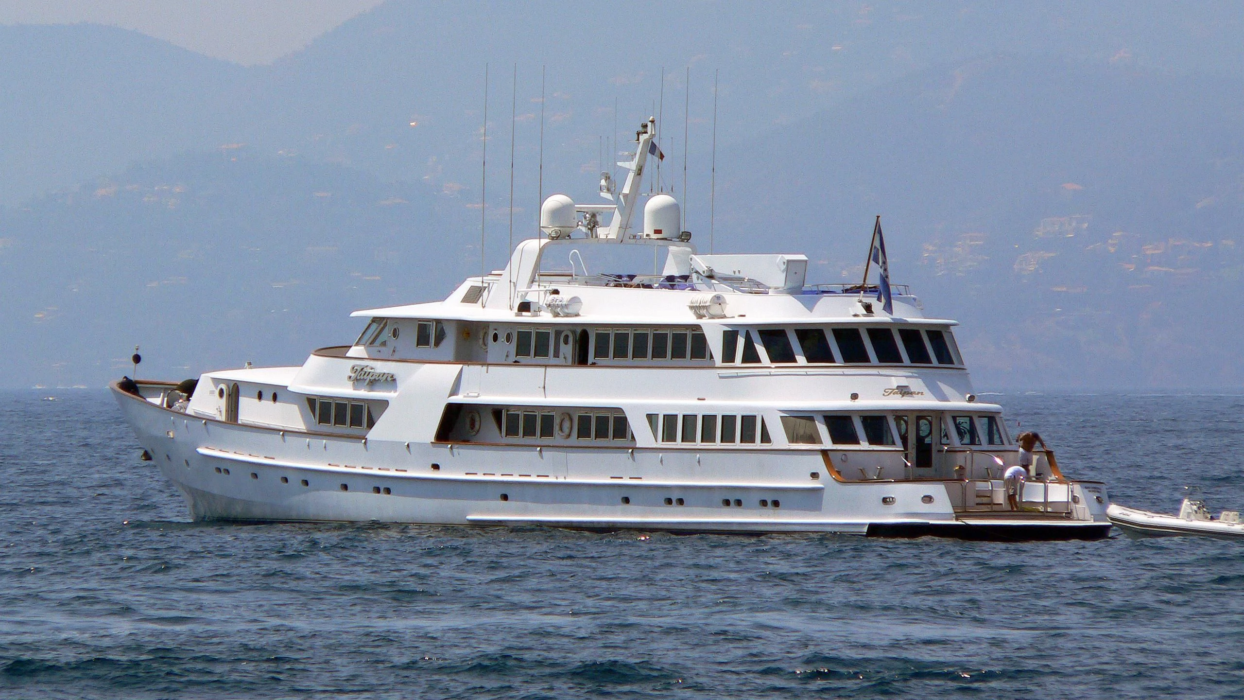 a large white boat in the water aboard WIND OF FORTUNE Yacht for Charter