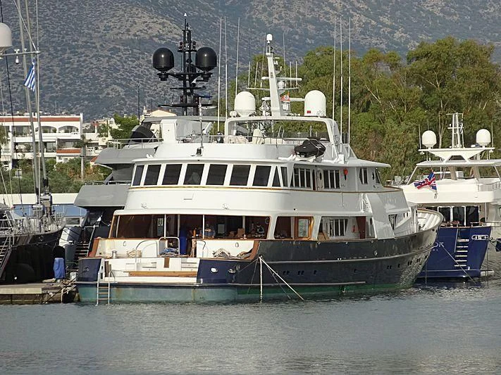 a large boat docked at a pier aboard WIND OF FORTUNE Yacht for Charter