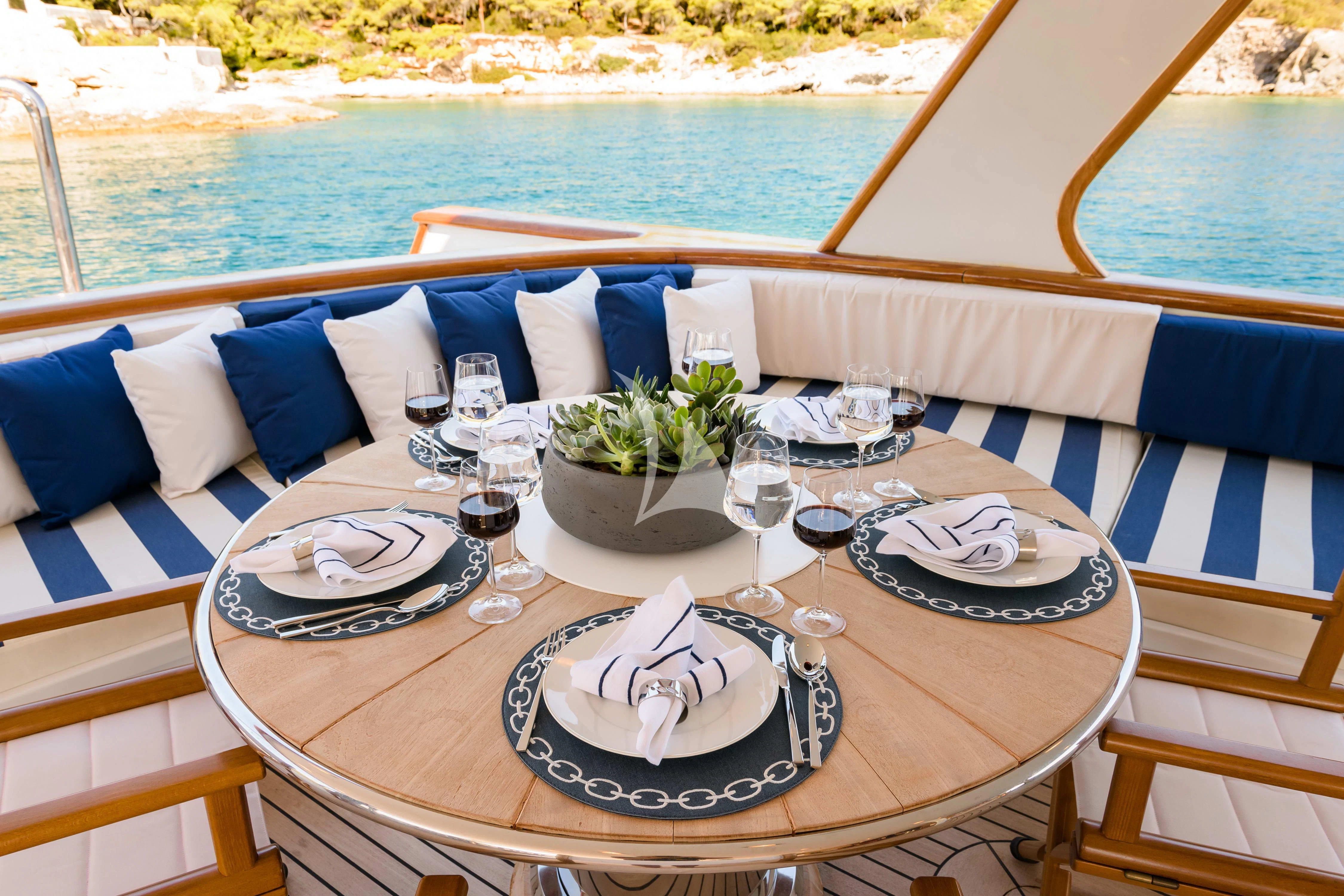 a table with plates and glasses on it aboard WIND OF FORTUNE Yacht for Charter