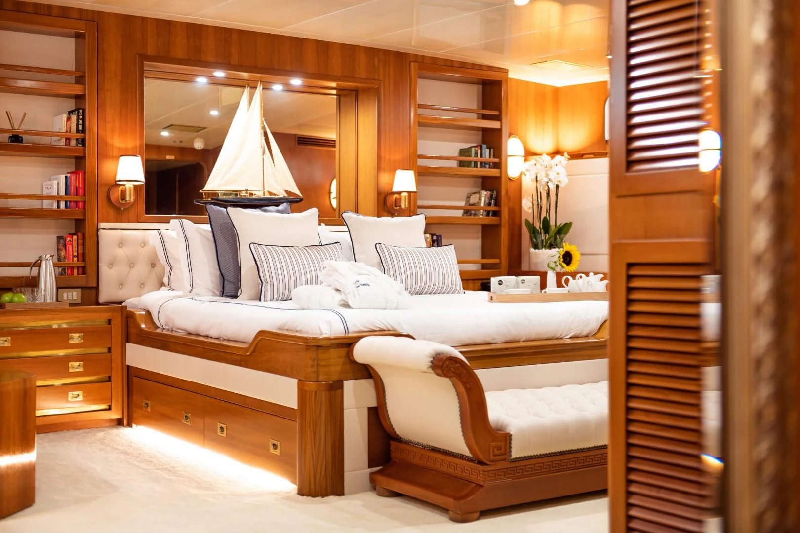 a room with a bed and a couch aboard WIND OF FORTUNE Yacht for Charter