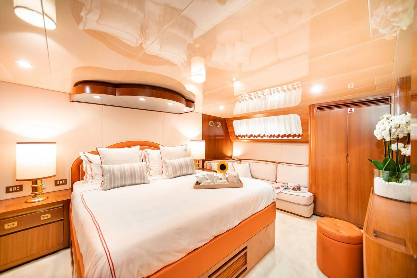 a bedroom with a bed and a wood door aboard WIND OF FORTUNE Yacht for Charter
