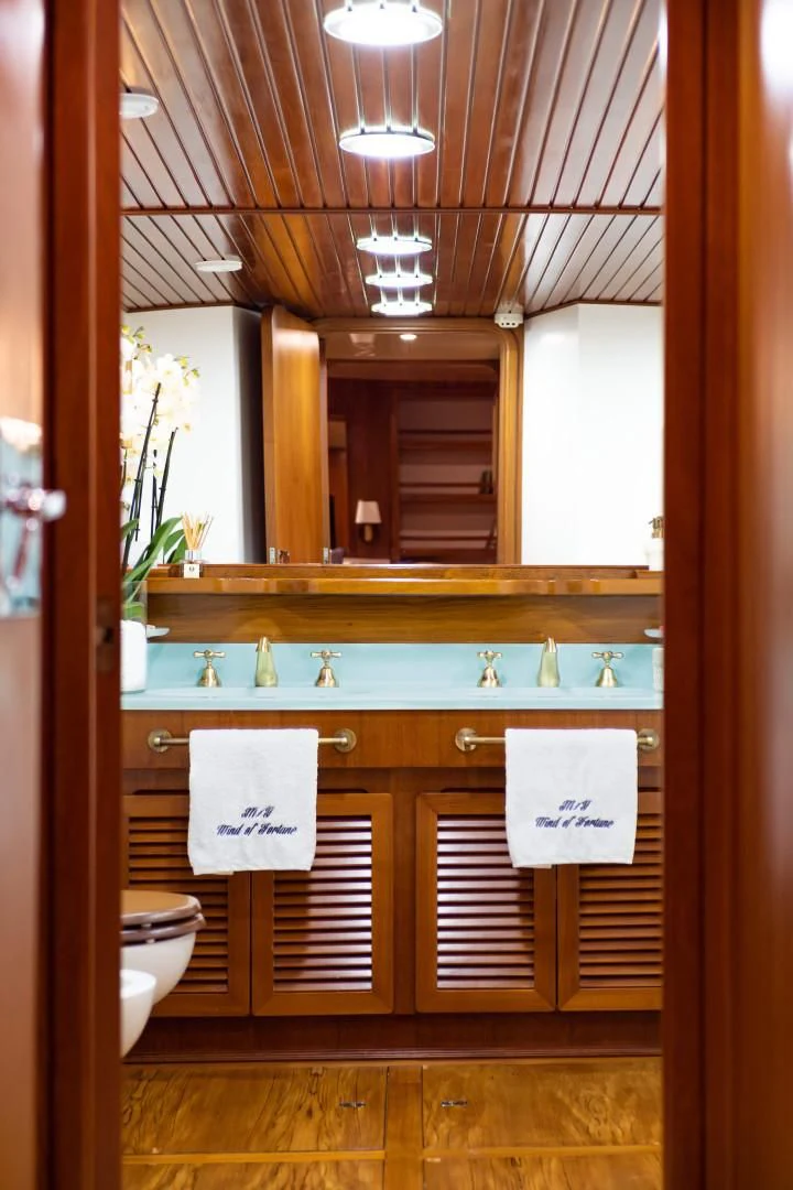 a bathroom with a sink and a mirror aboard WIND OF FORTUNE Yacht for Charter