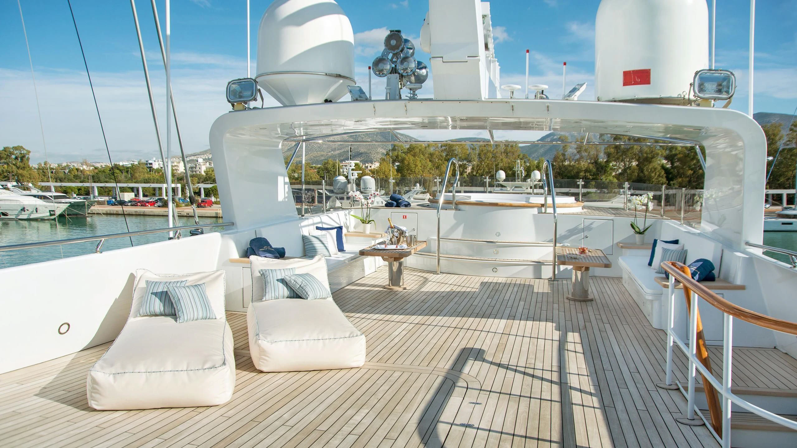 a deck with chairs and tables on it aboard WIND OF FORTUNE Yacht for Charter