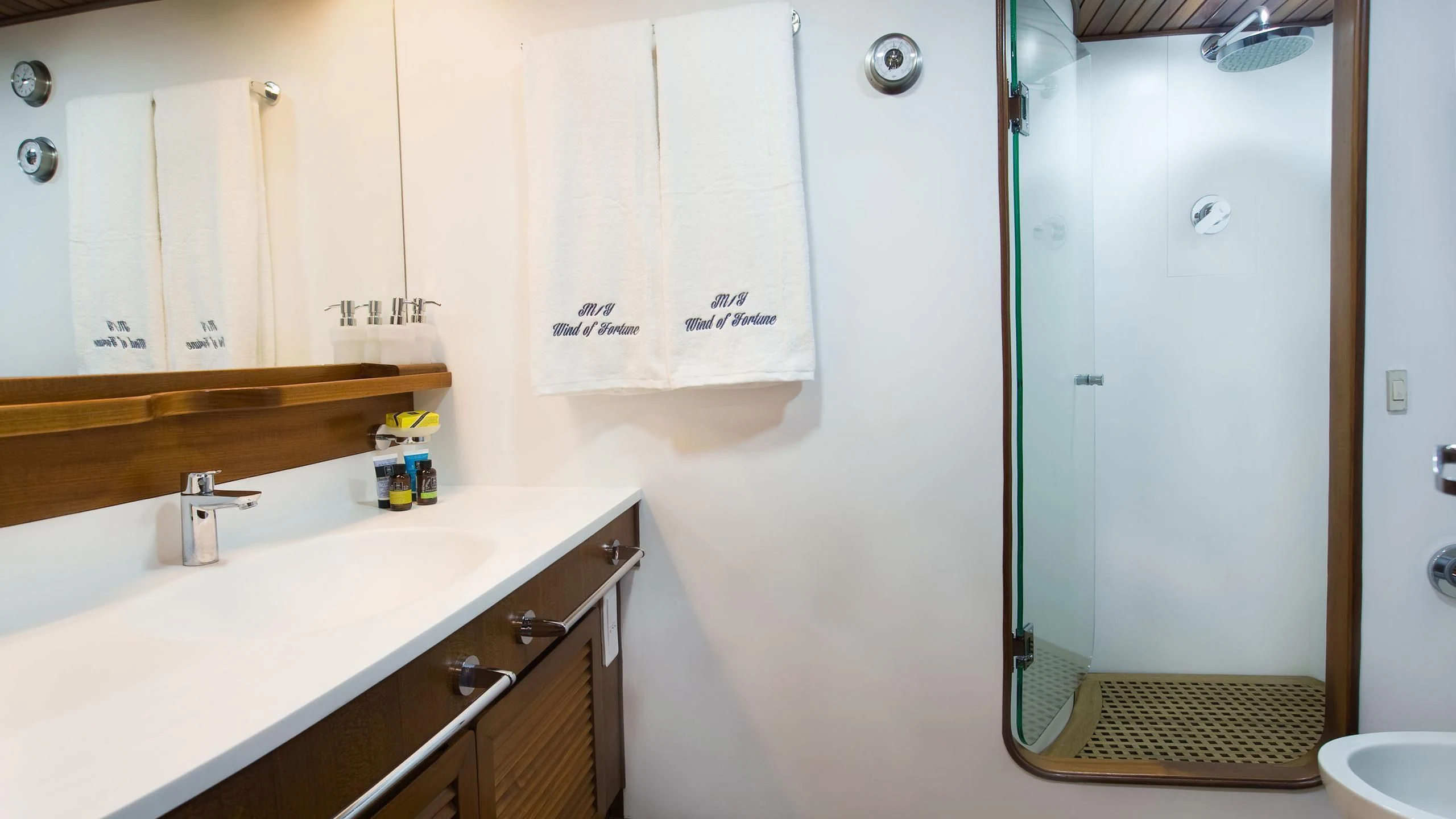 a bathroom with a sink and a shower aboard WIND OF FORTUNE Yacht for Charter