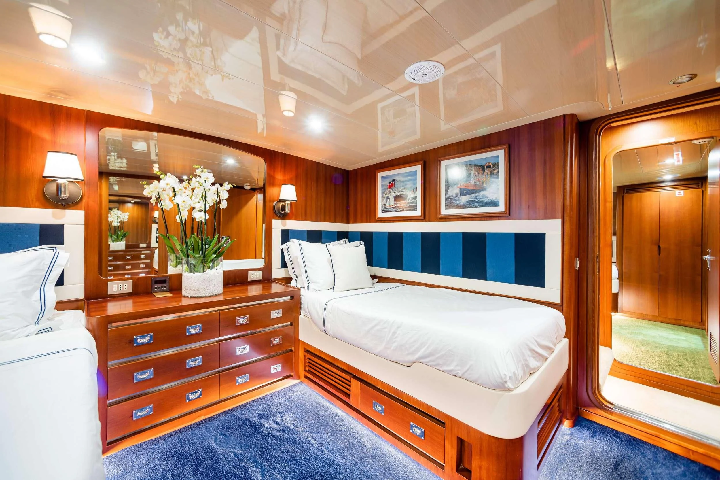 a room with a bed and a mirror aboard WIND OF FORTUNE Yacht for Charter