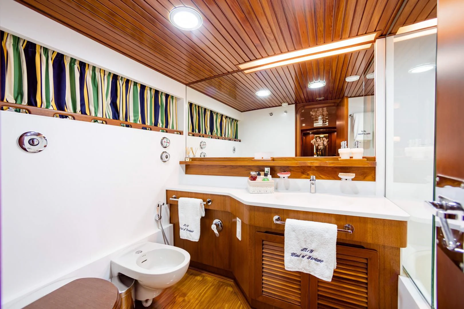 a bathroom with a toilet and a sink aboard WIND OF FORTUNE Yacht for Charter