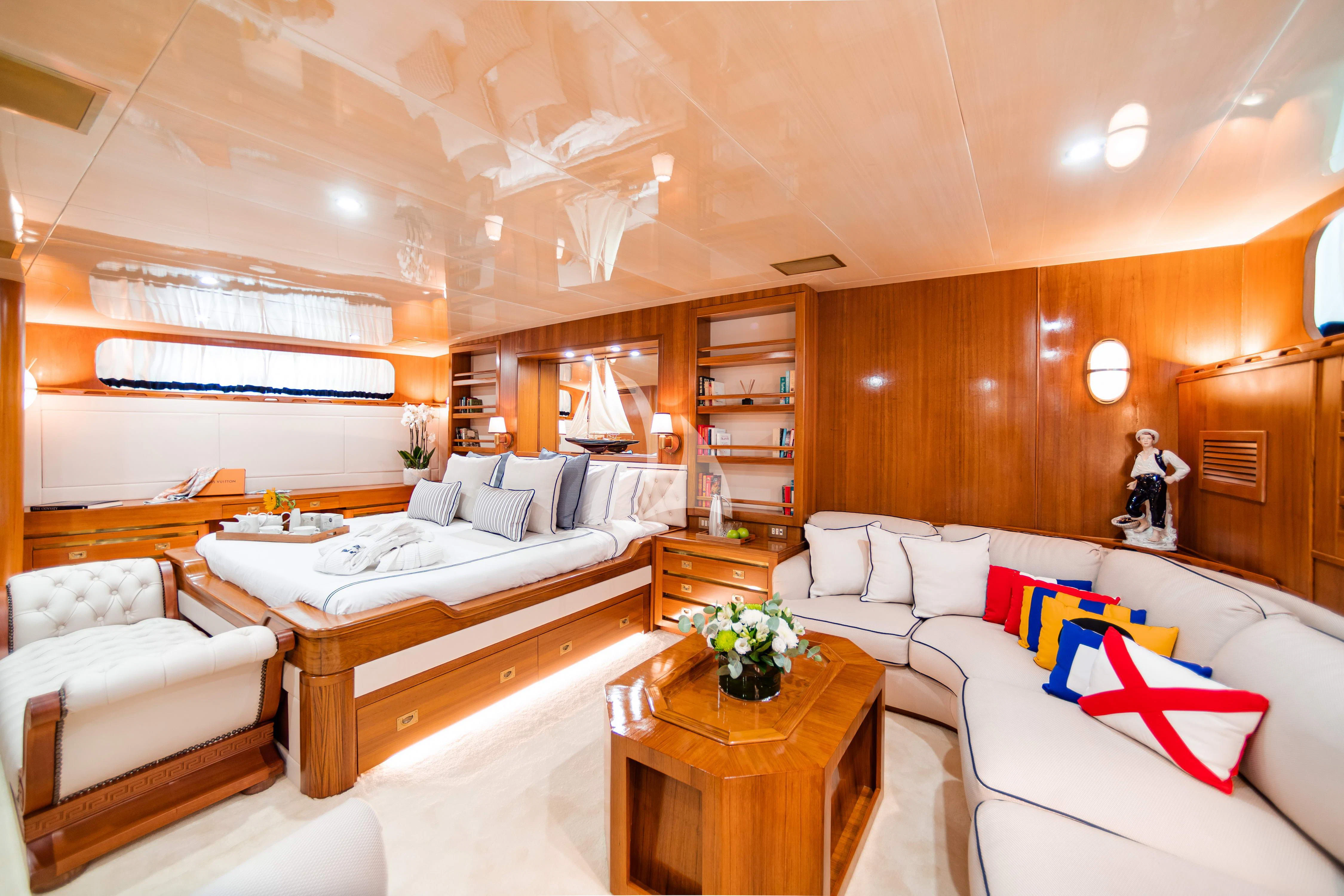 a room with a bed and a table aboard WIND OF FORTUNE Yacht for Charter
