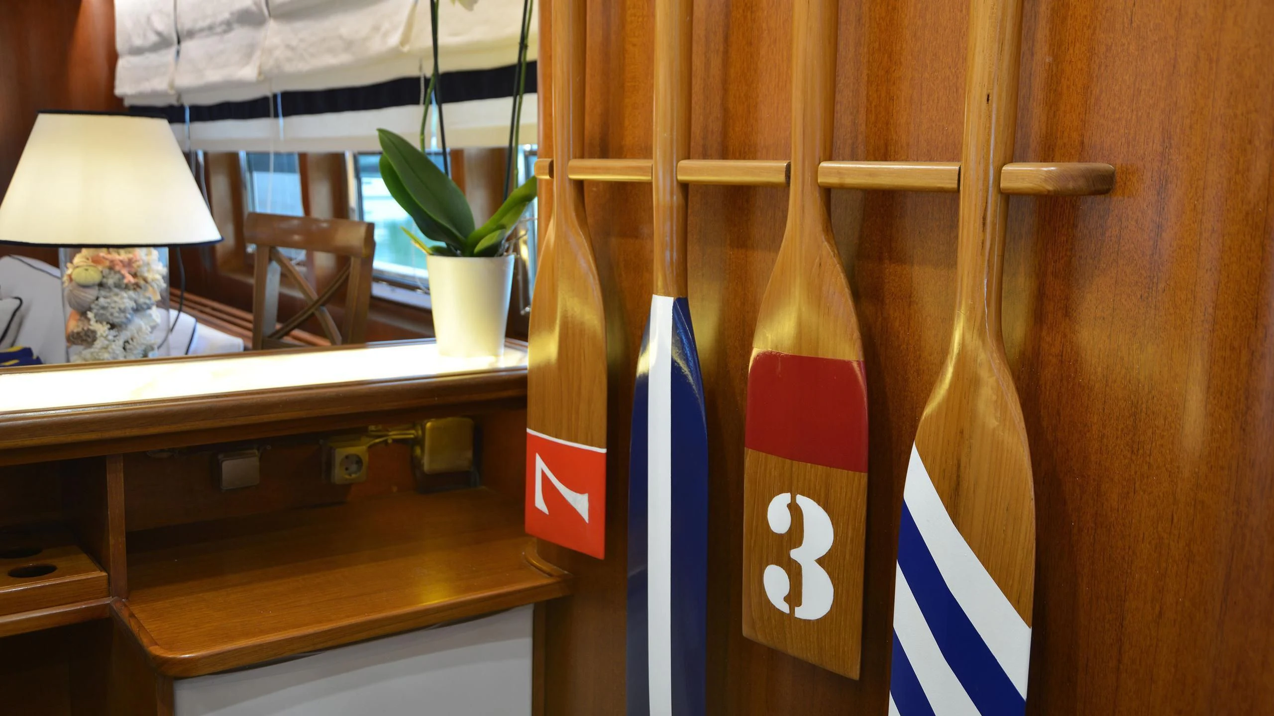 a wood shelf with a vase and a plant on it aboard WIND OF FORTUNE Yacht for Charter