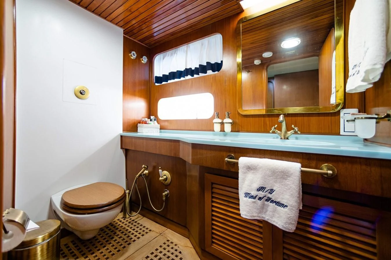 a bathroom with a toilet and a sink aboard WIND OF FORTUNE Yacht for Charter