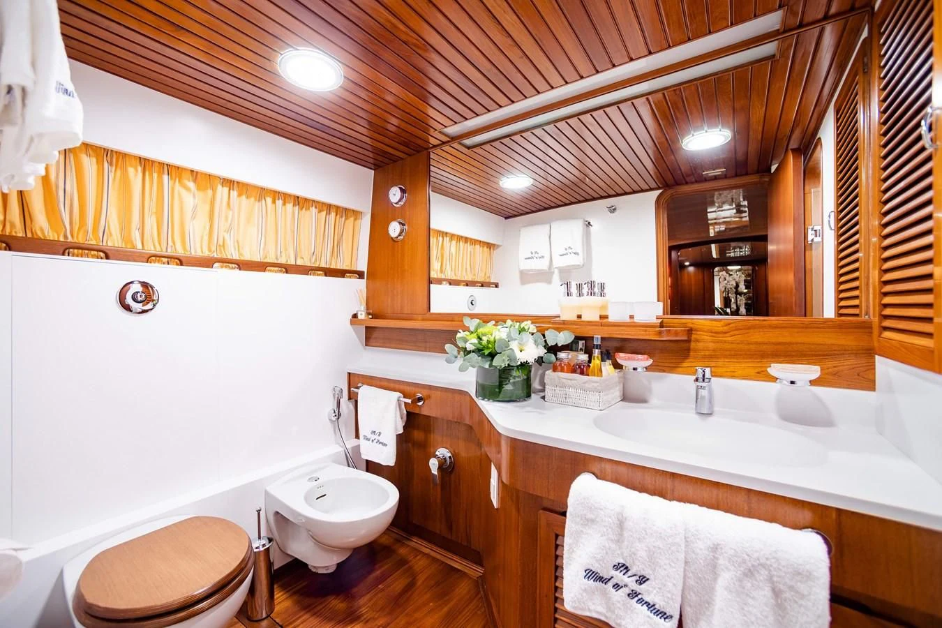 a bathroom with a toilet and sink aboard WIND OF FORTUNE Yacht for Charter