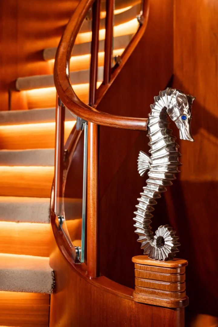 a wooden chair with a white flower on it aboard WIND OF FORTUNE Yacht for Charter