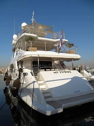 a large white boat with flags on it aboard MY TWINZZ Yacht for Sale