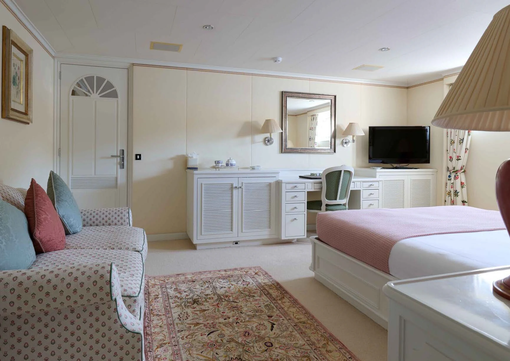 a bedroom with a bed and a tv aboard LADY BEATRICE Yacht for Sale