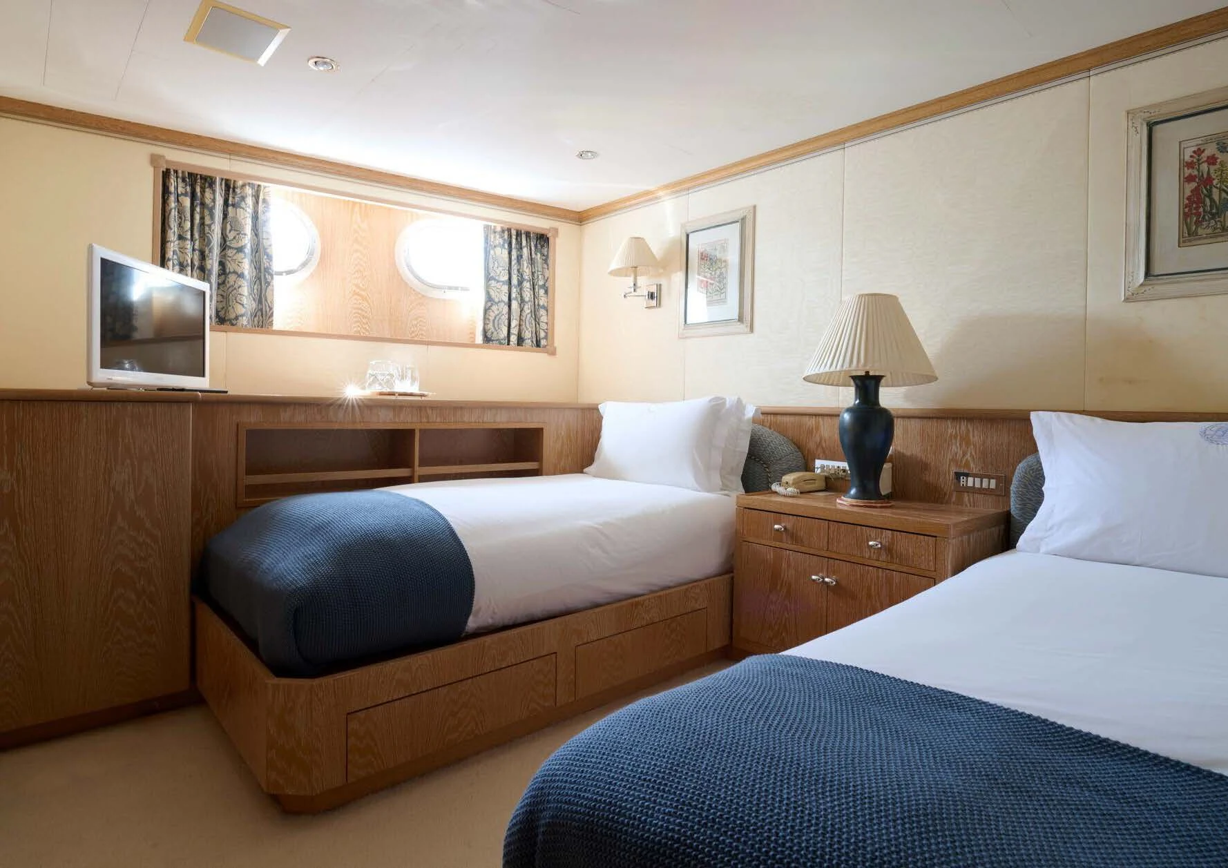 a bedroom with a bed and a television aboard LADY BEATRICE Yacht for Sale