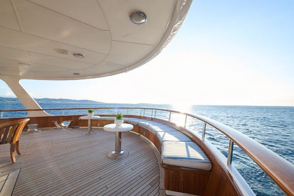 a deck with a view of the ocean and the ocean aboard LADY BEATRICE Yacht for Sale