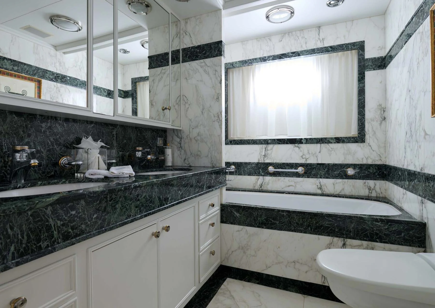 a bathroom with a tub sink and a sink aboard LADY BEATRICE Yacht for Sale