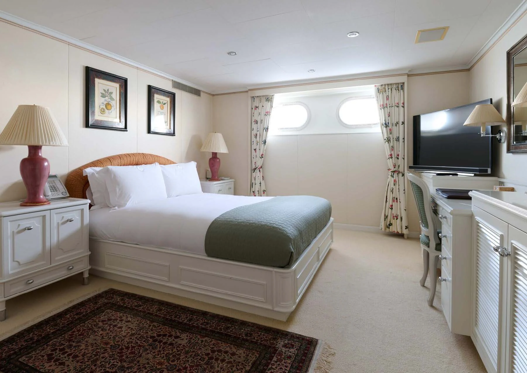 a bedroom with a bed and a television aboard LADY BEATRICE Yacht for Sale