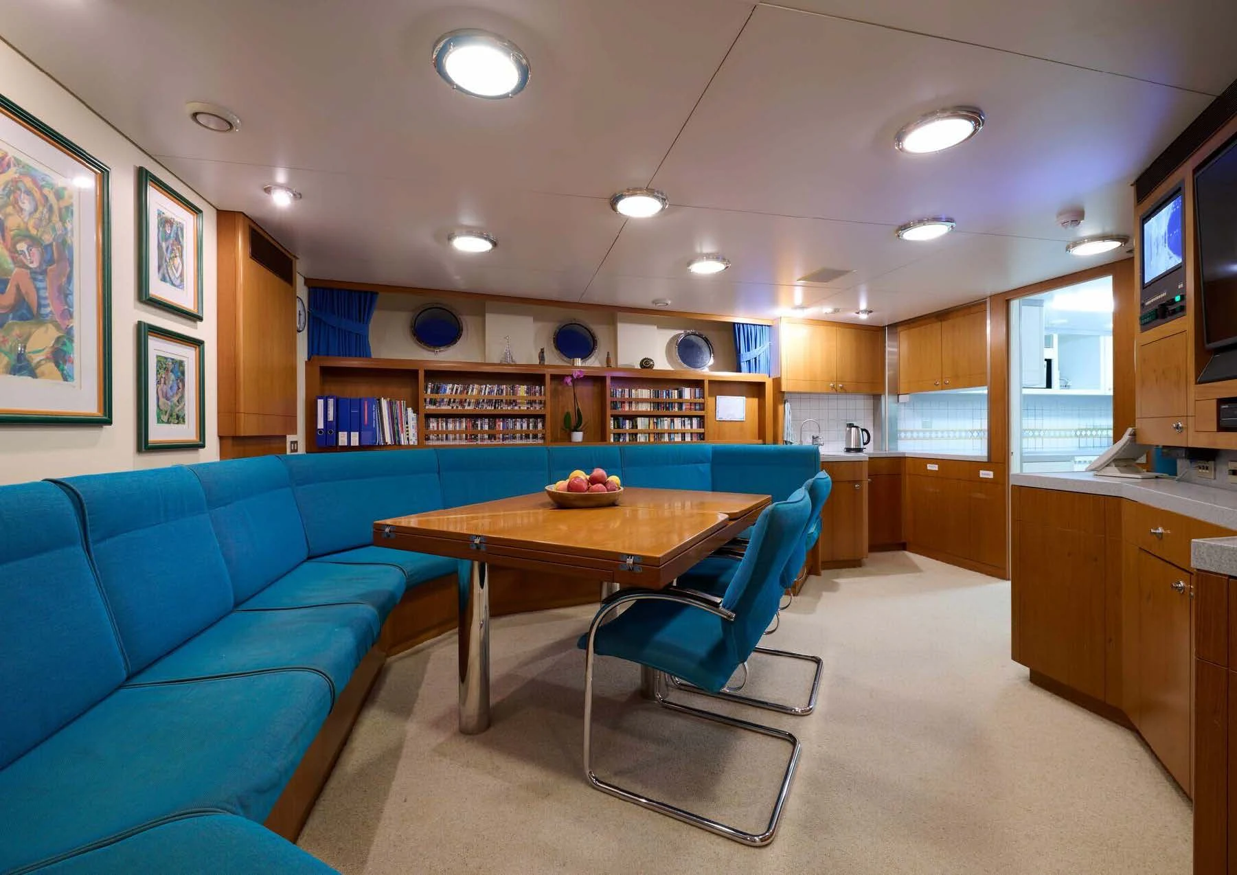 a room with a table and a couch aboard LADY BEATRICE Yacht for Sale