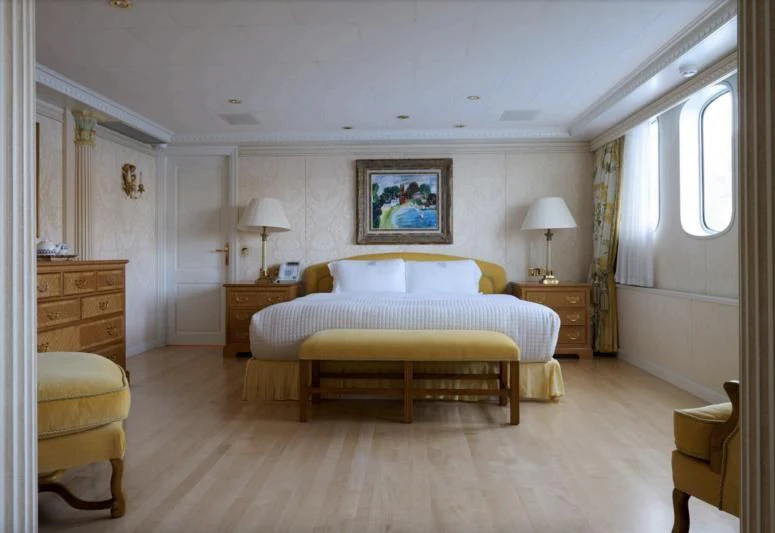 a bedroom with a bed and a desk aboard LADY BEATRICE Yacht for Sale