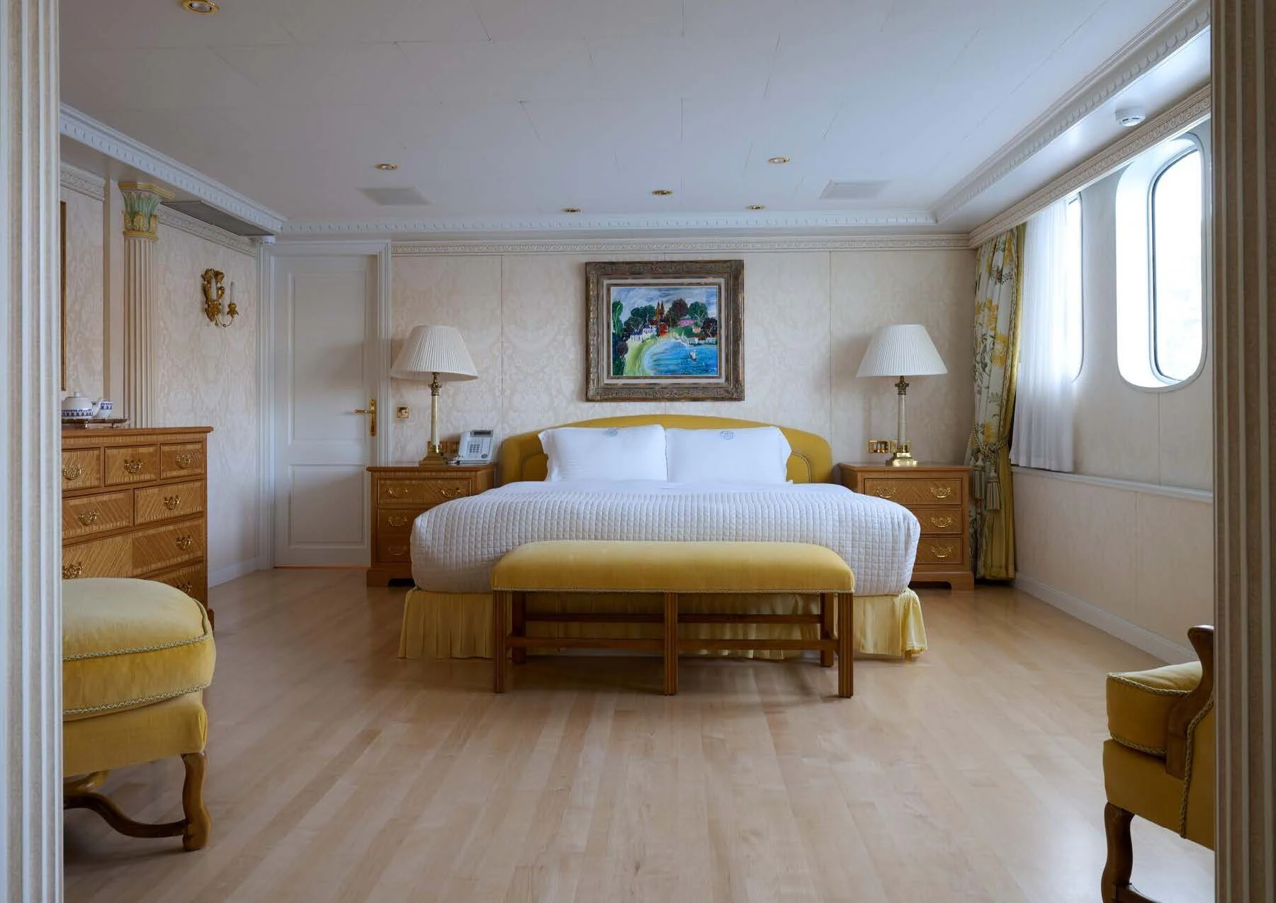 a bedroom with a bed and a lamp aboard LADY BEATRICE Yacht for Sale