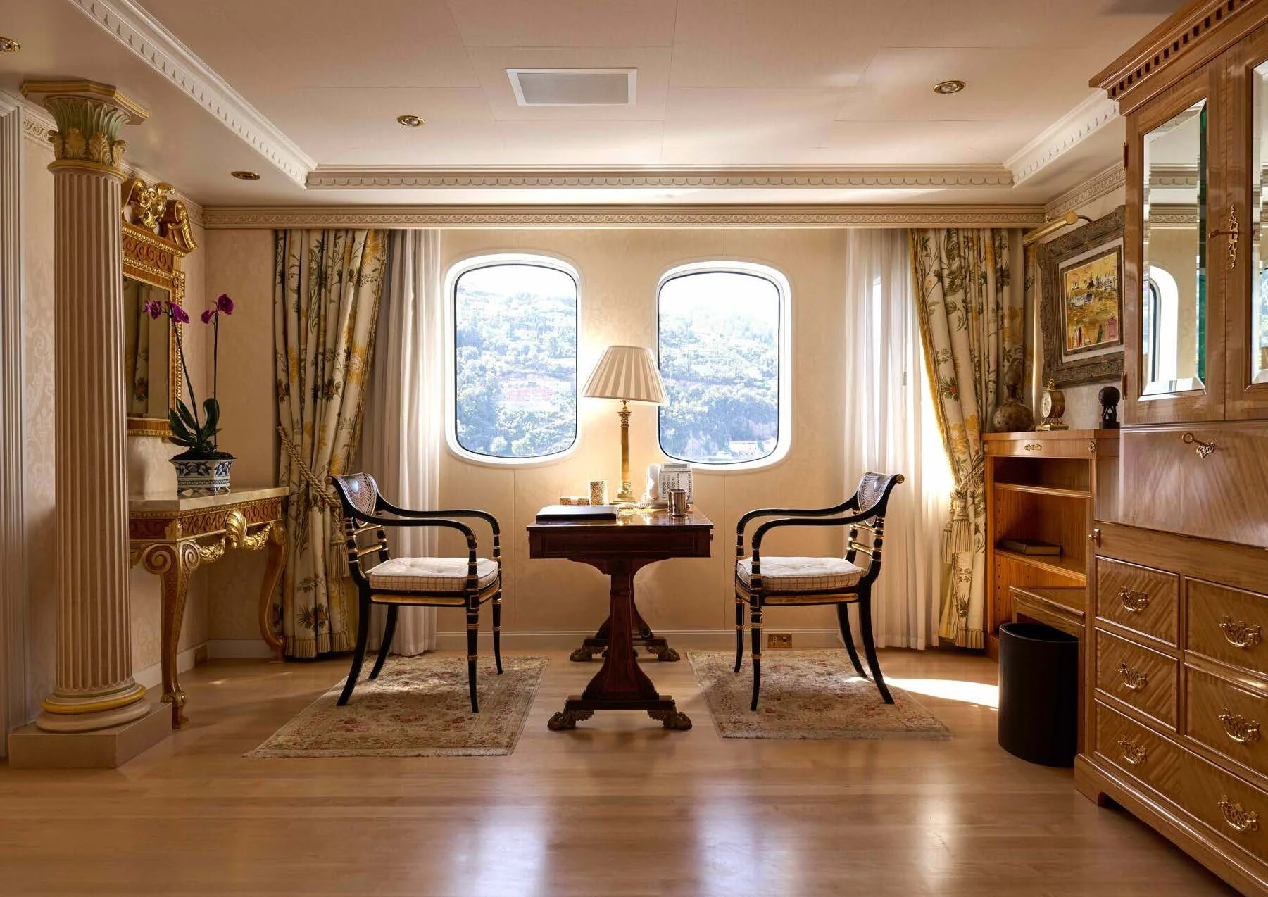 a room with a table chairs and a window aboard LADY BEATRICE Yacht for Sale