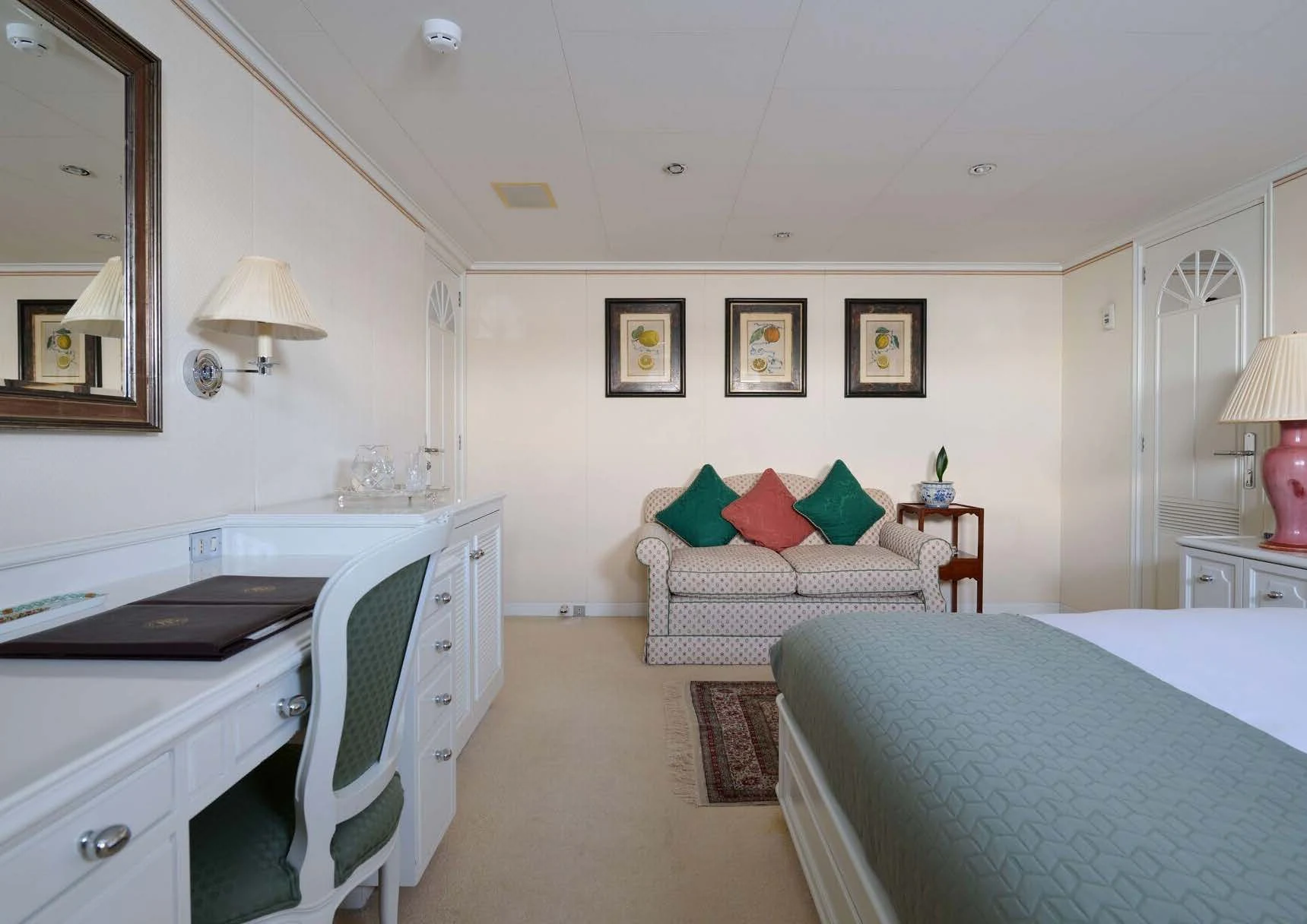 a bedroom with a bed and a desk aboard LADY BEATRICE Yacht for Sale