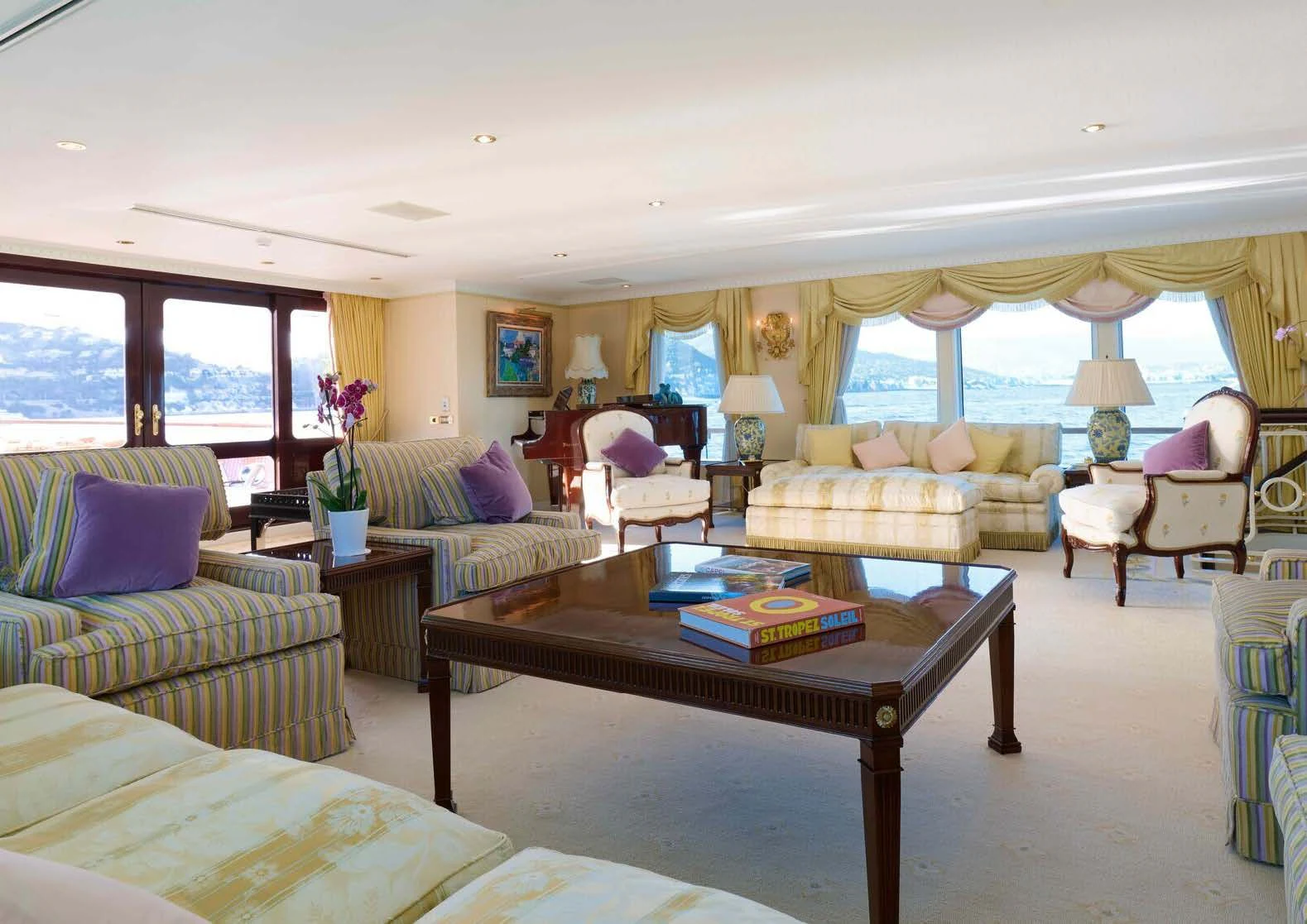 a living room with a table and couches aboard LADY BEATRICE Yacht for Sale