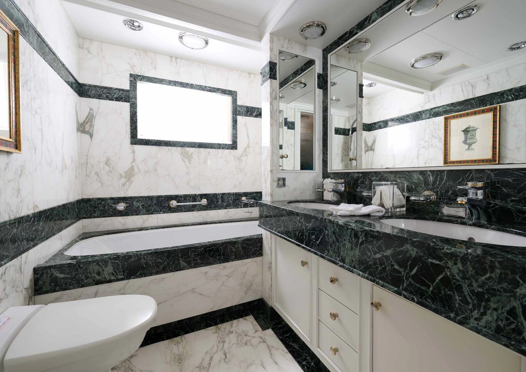 a bathroom with a tub sink and a sink aboard LADY BEATRICE Yacht for Sale
