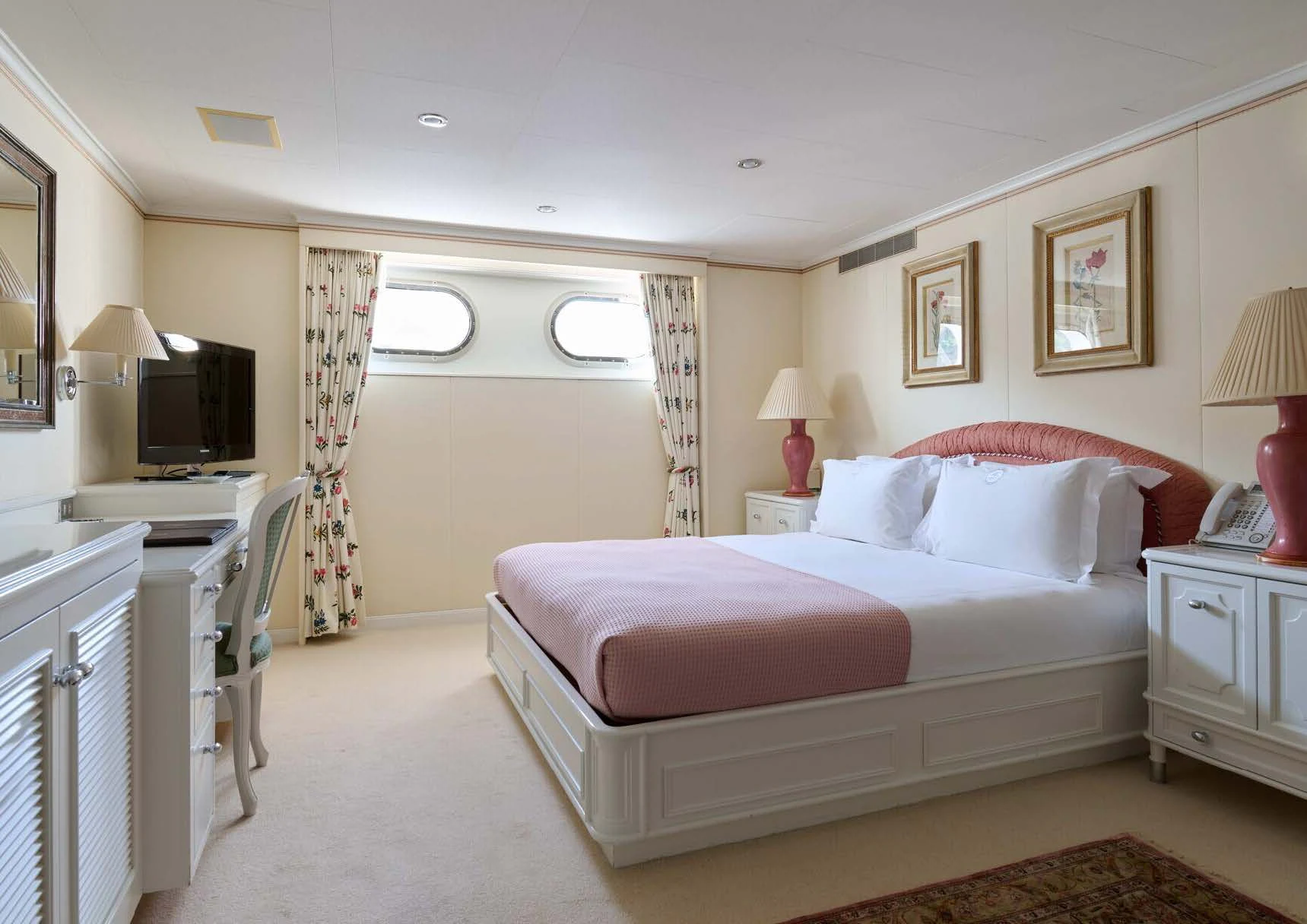 a bedroom with a bed and a television aboard LADY BEATRICE Yacht for Sale