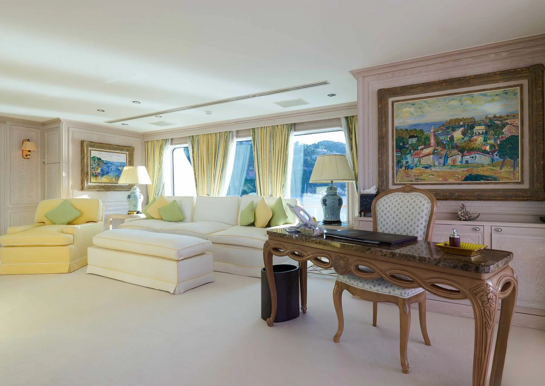 a living room with a table and couches aboard LADY BEATRICE Yacht for Sale