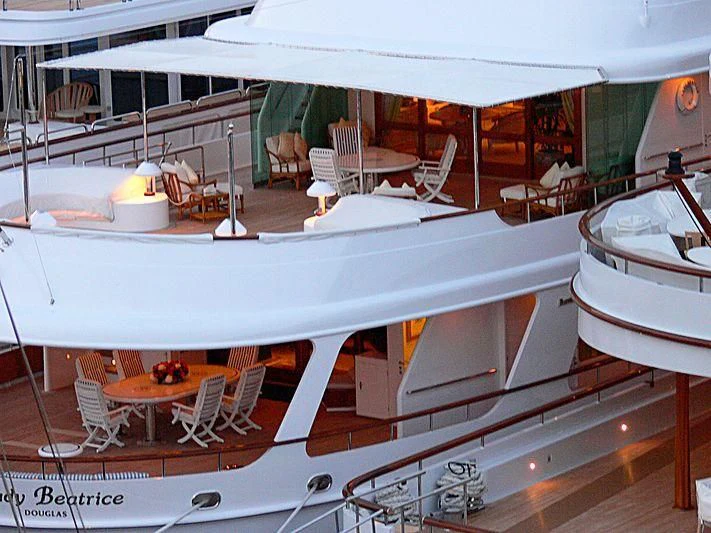 a large white boat with tables and chairs aboard LADY BEATRICE Yacht for Sale