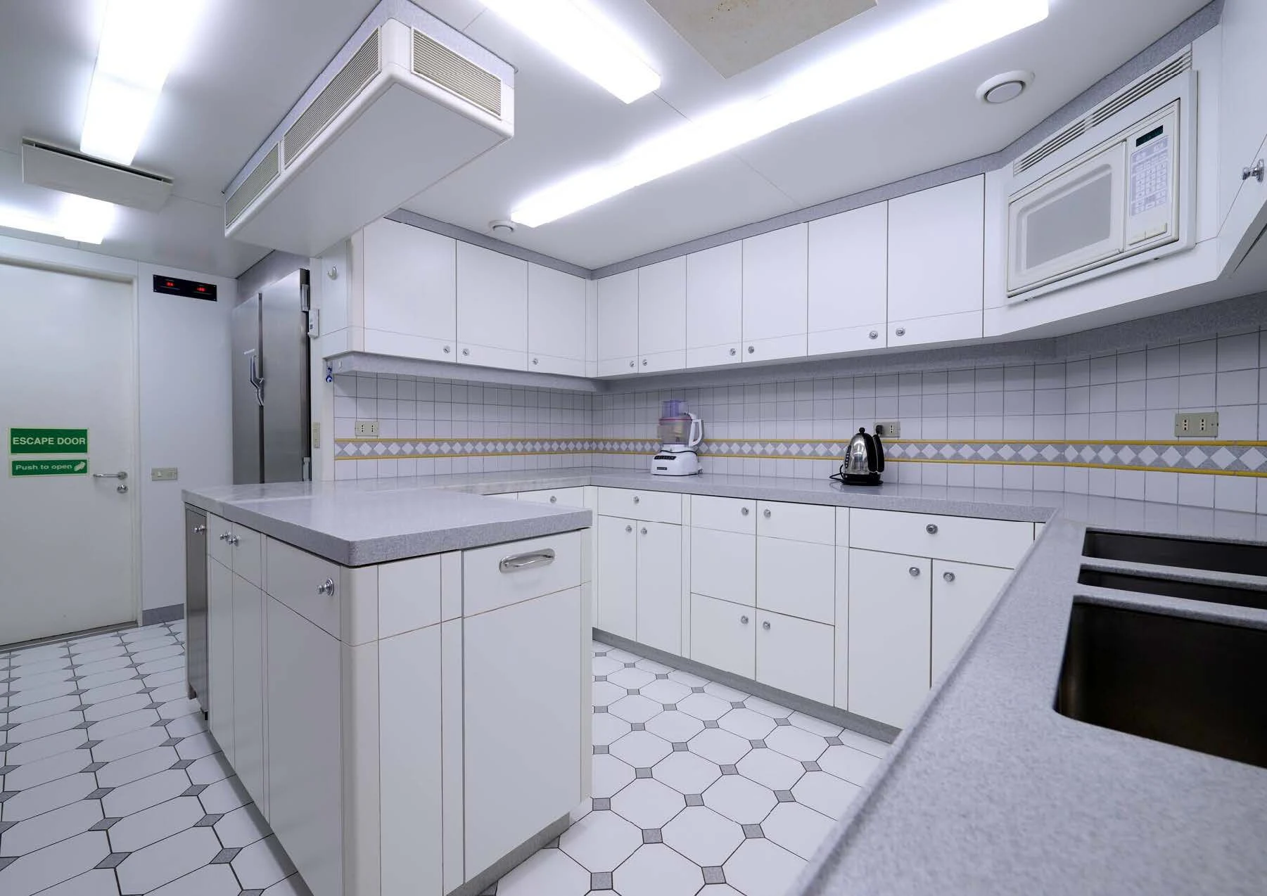 a kitchen with white cabinets aboard LADY BEATRICE Yacht for Sale