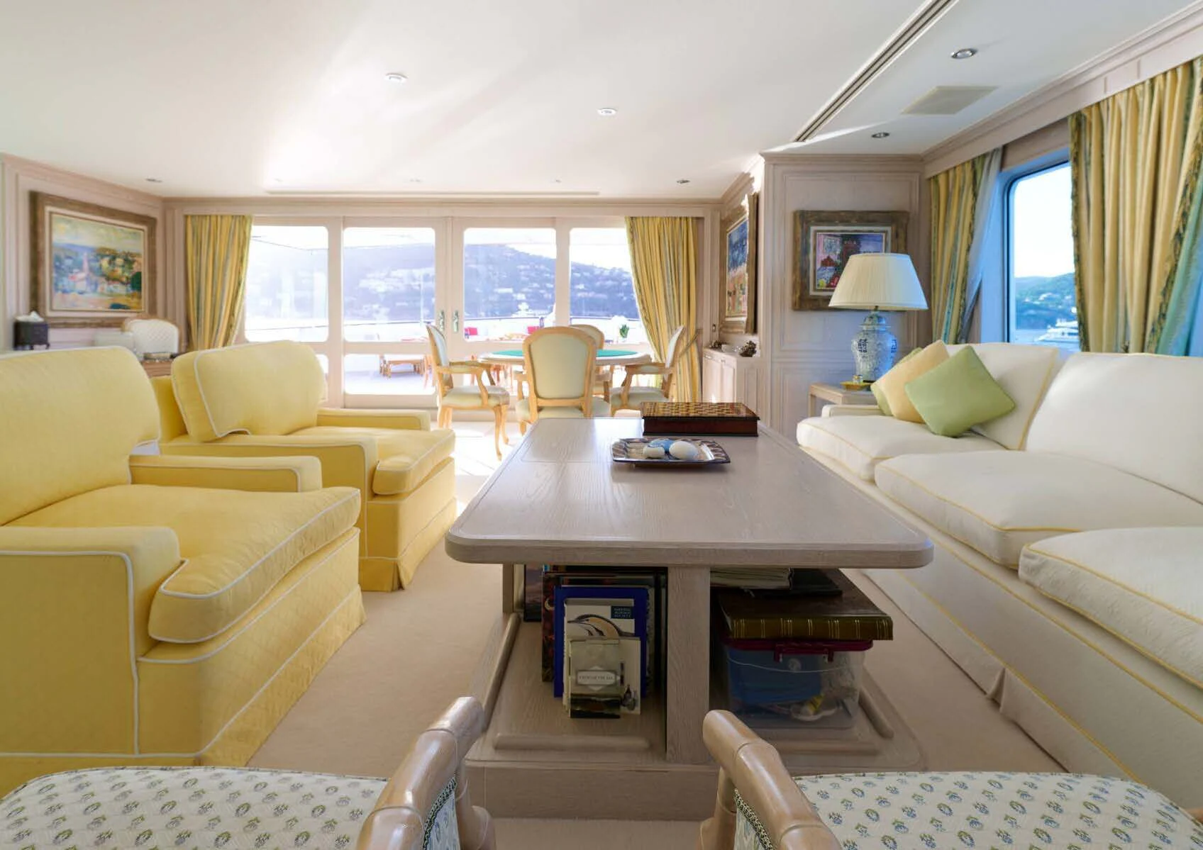 a living room with a table and couches aboard LADY BEATRICE Yacht for Sale