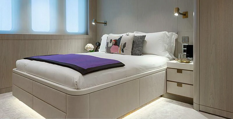 a bed with purple sheets aboard PROMISE Yacht for Sale