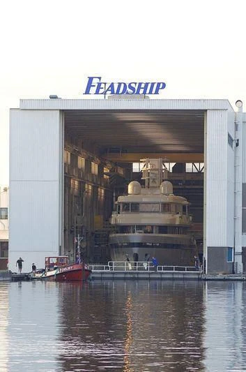 a large building with a large boat in the water aboard PROMISE Yacht for Sale