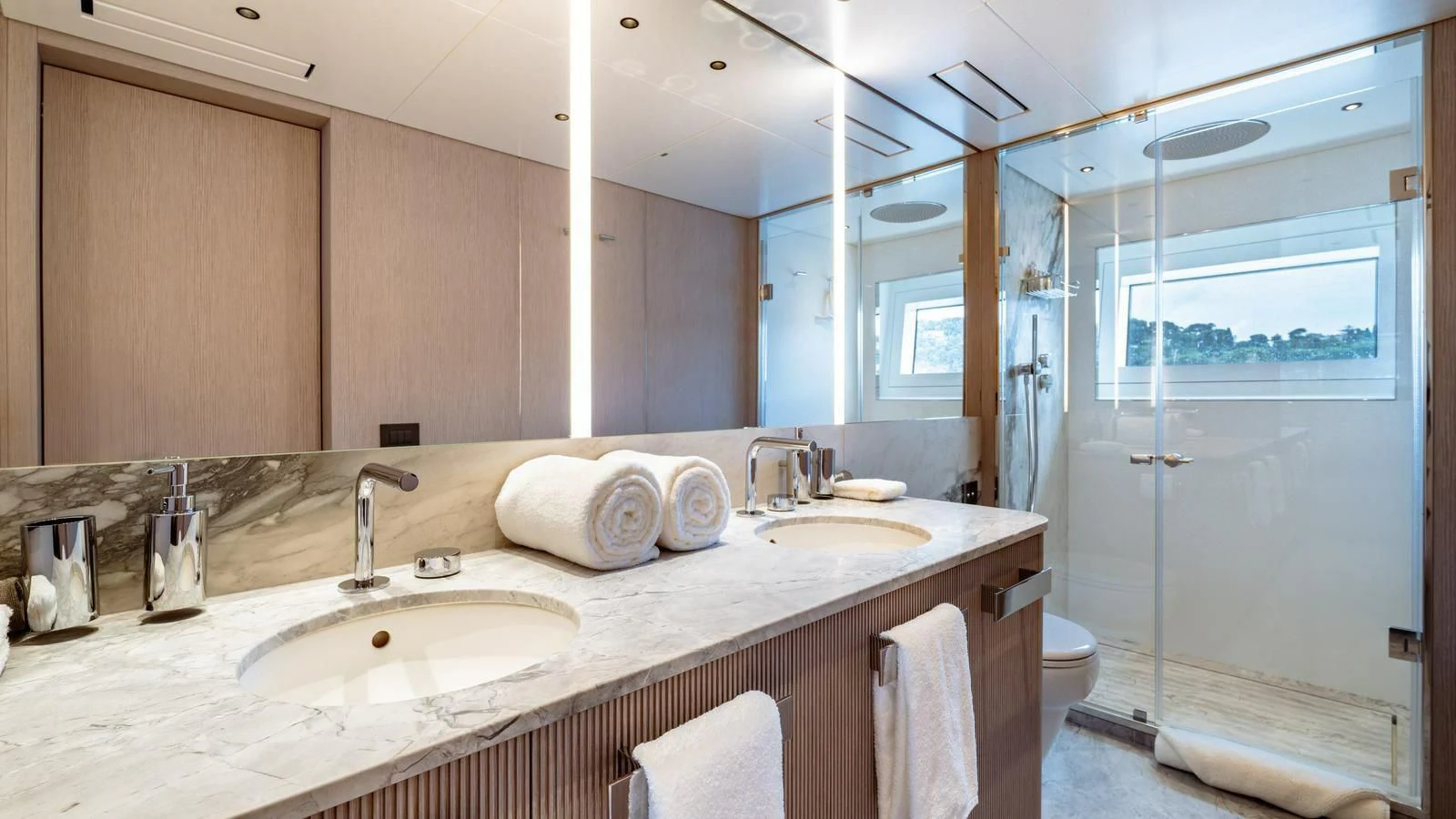 a bathroom with a glass shower door aboard WAVE Yacht for Sale