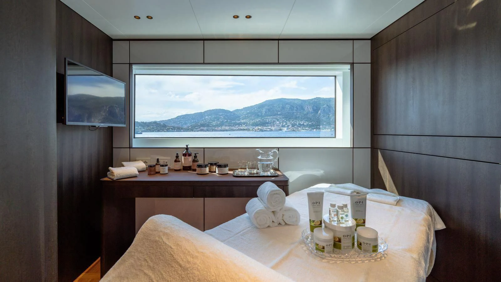 a room with a bed and a television aboard WAVE Yacht for Sale