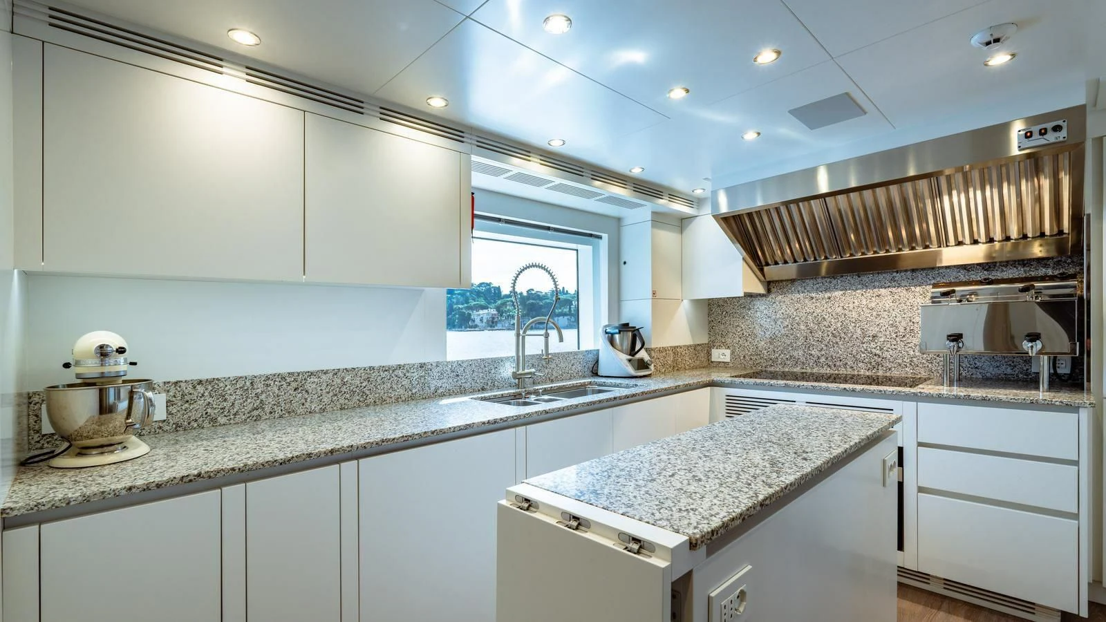 a kitchen with white cabinets aboard WAVE Yacht for Sale